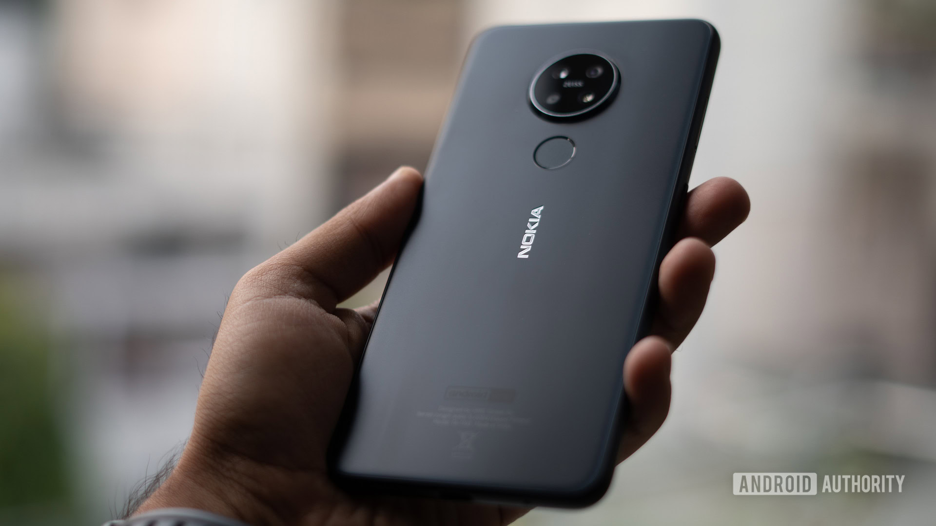 Nokia 7.2 with rear panel in hand