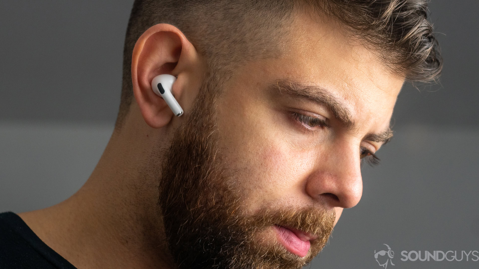 A picture of a man wearing the Apple AirPods Pro (1st generation) noise-canceling true wireless earbuds.