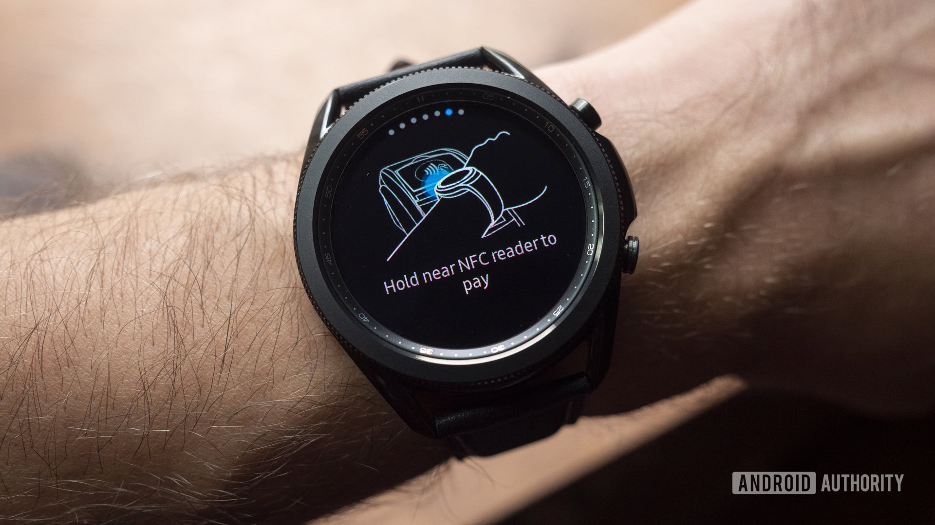 A Samsung Galaxy Watch 3 on a user's wrist displays the Samsung Pay screen.