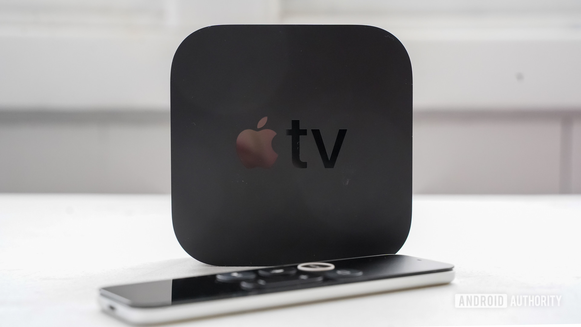 Apple TV 4K standing with remote control
