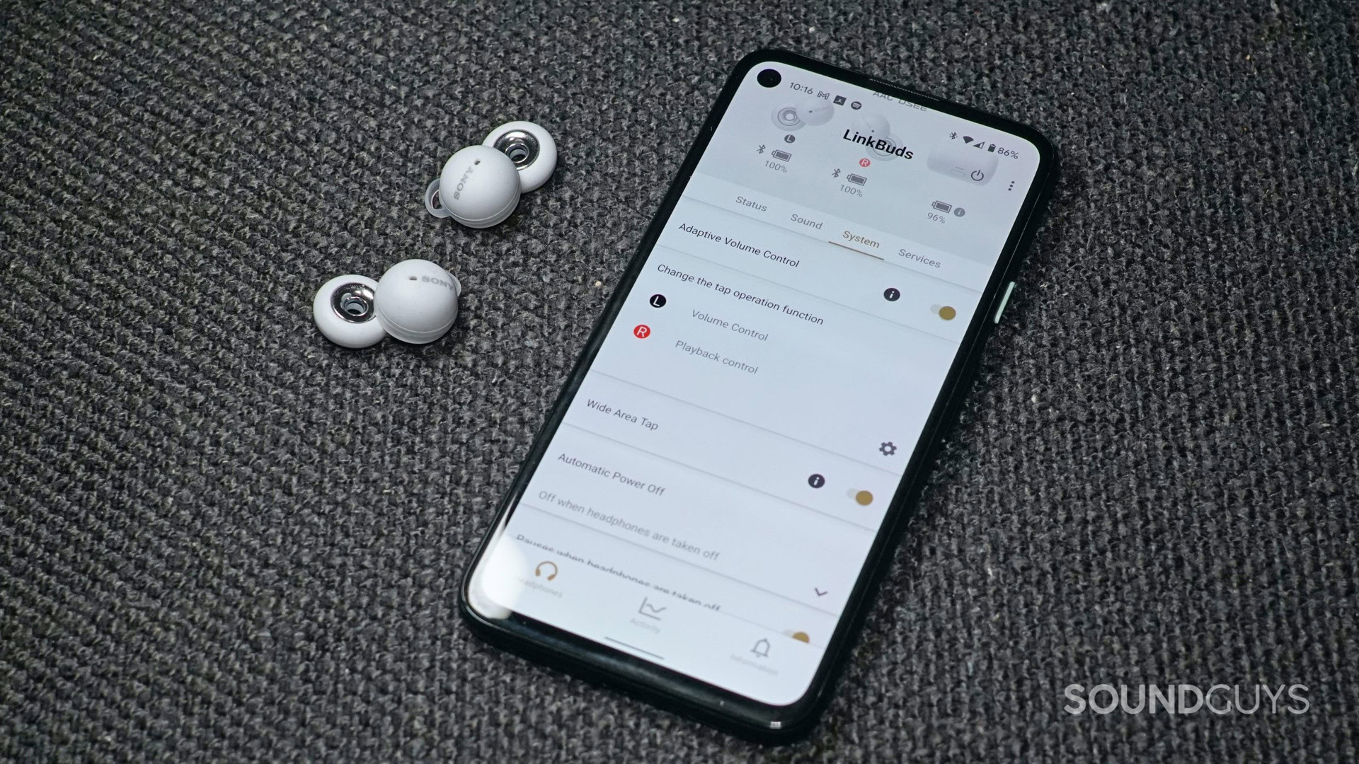 Sony LinkBuds next to a phone with the Sony Headphones connect app open.