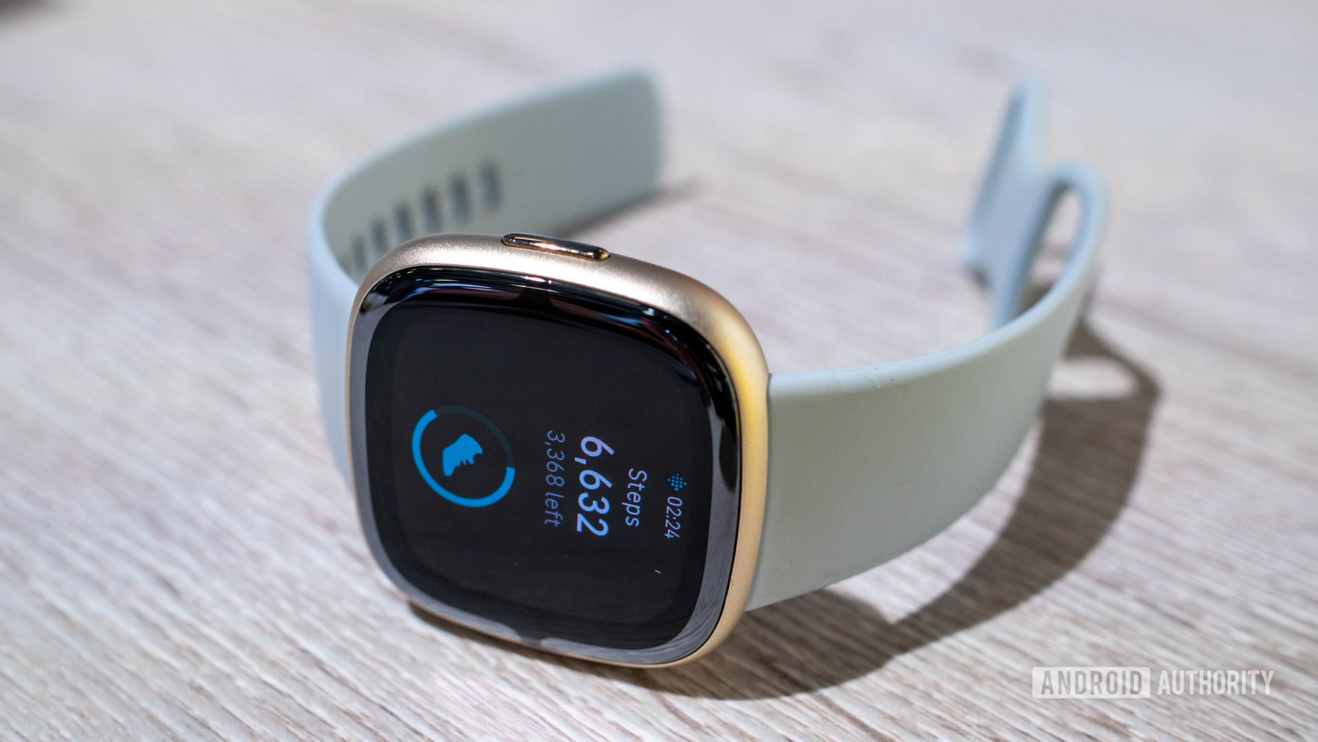 A Fitbit Sense 2 displays a user's step count