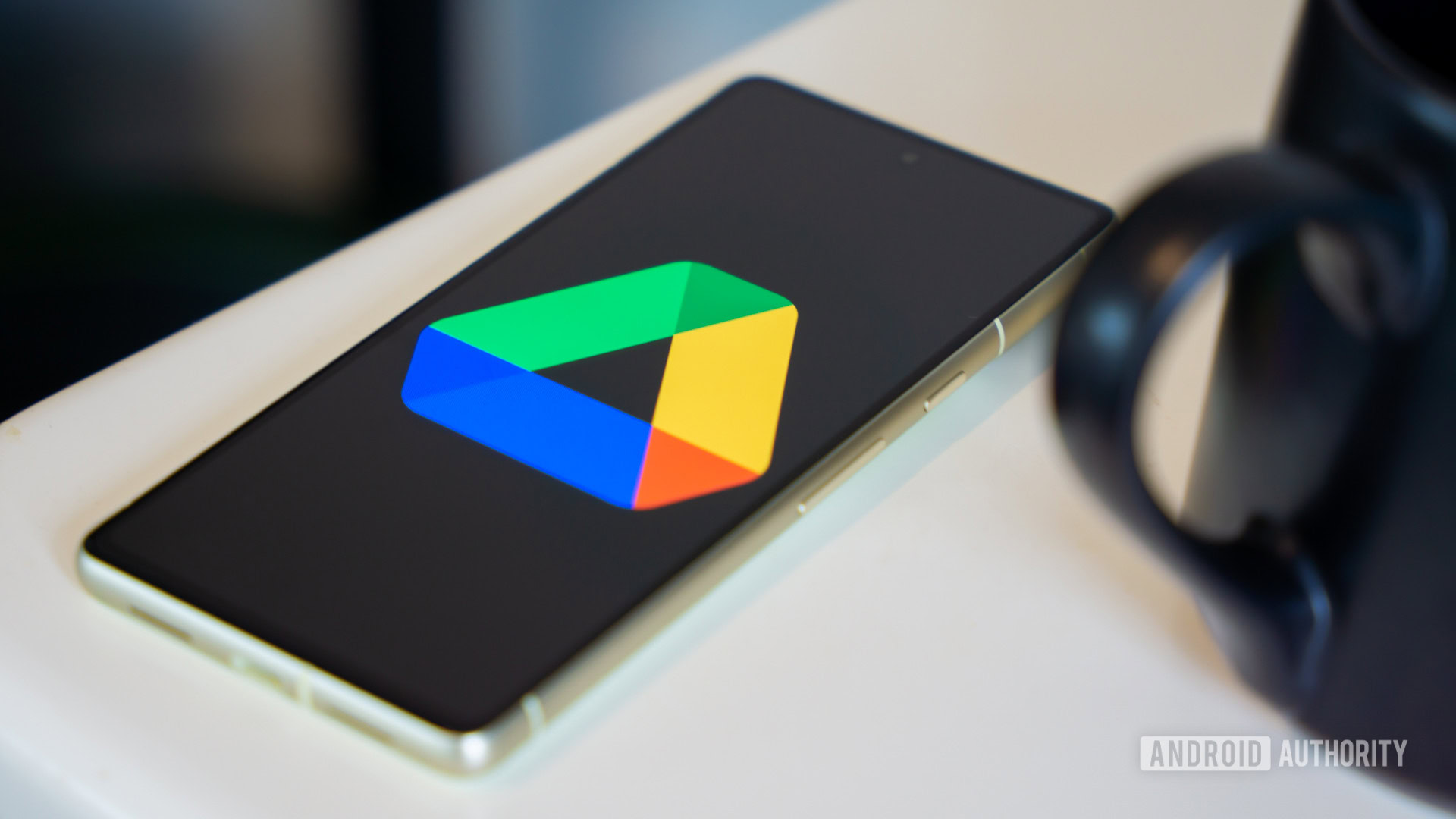 Google Drive logo on smartphone laying on desk Stock photo 1