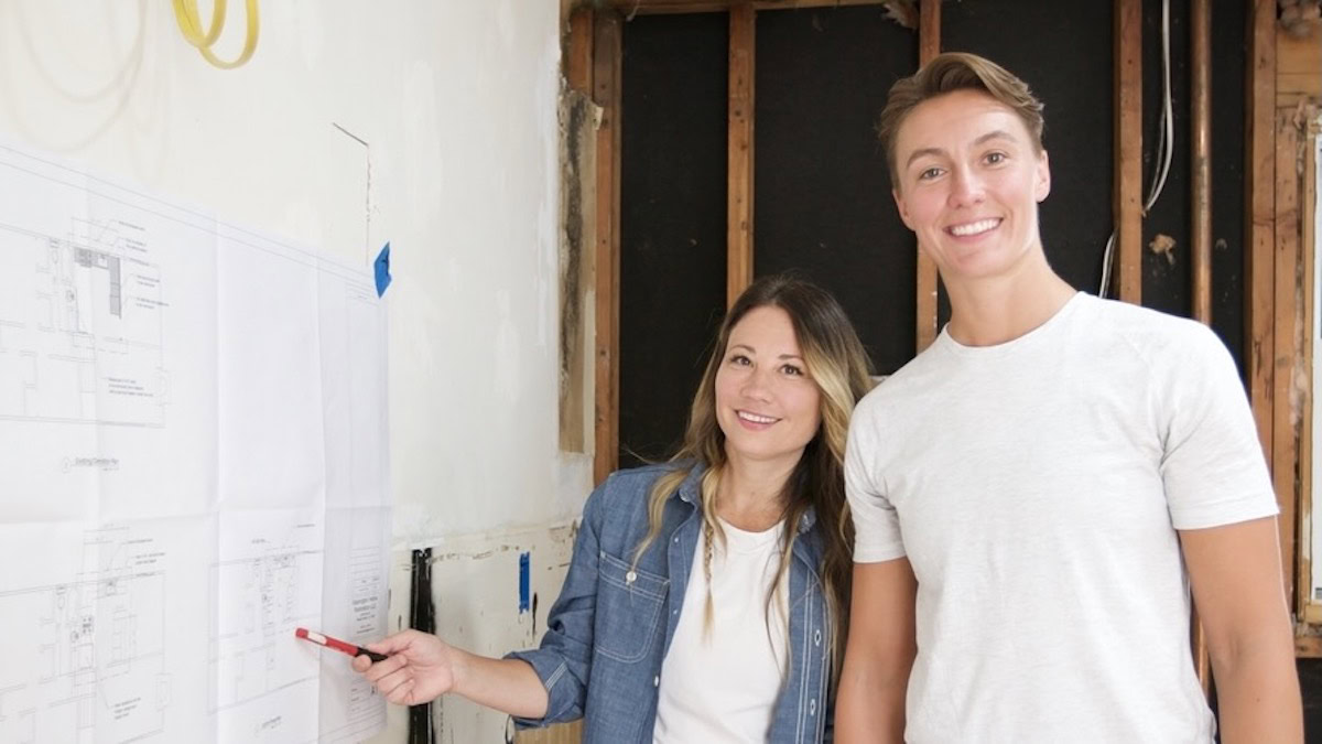 Davina and Kristin stand in front of a whiteboard in Small Town Potential