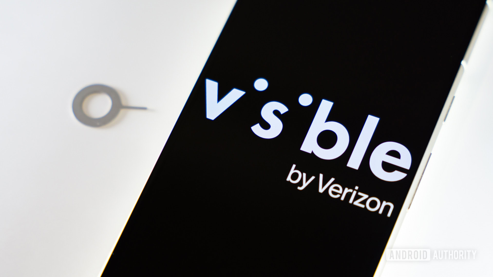 Visible by Verizon logo on smartphone next to SIM ejector tool