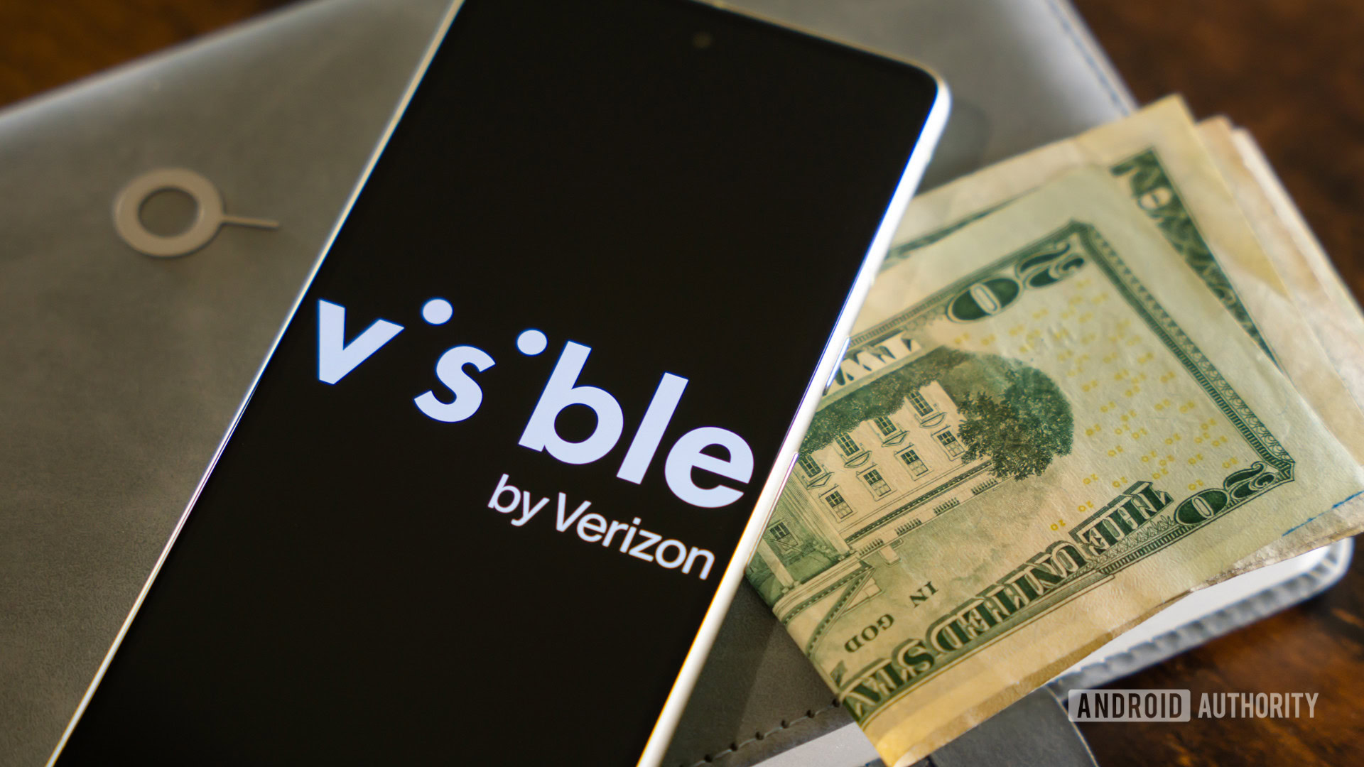 Visible by the Verizon logo on the smartphone, next to money and SIM eject tool (1)