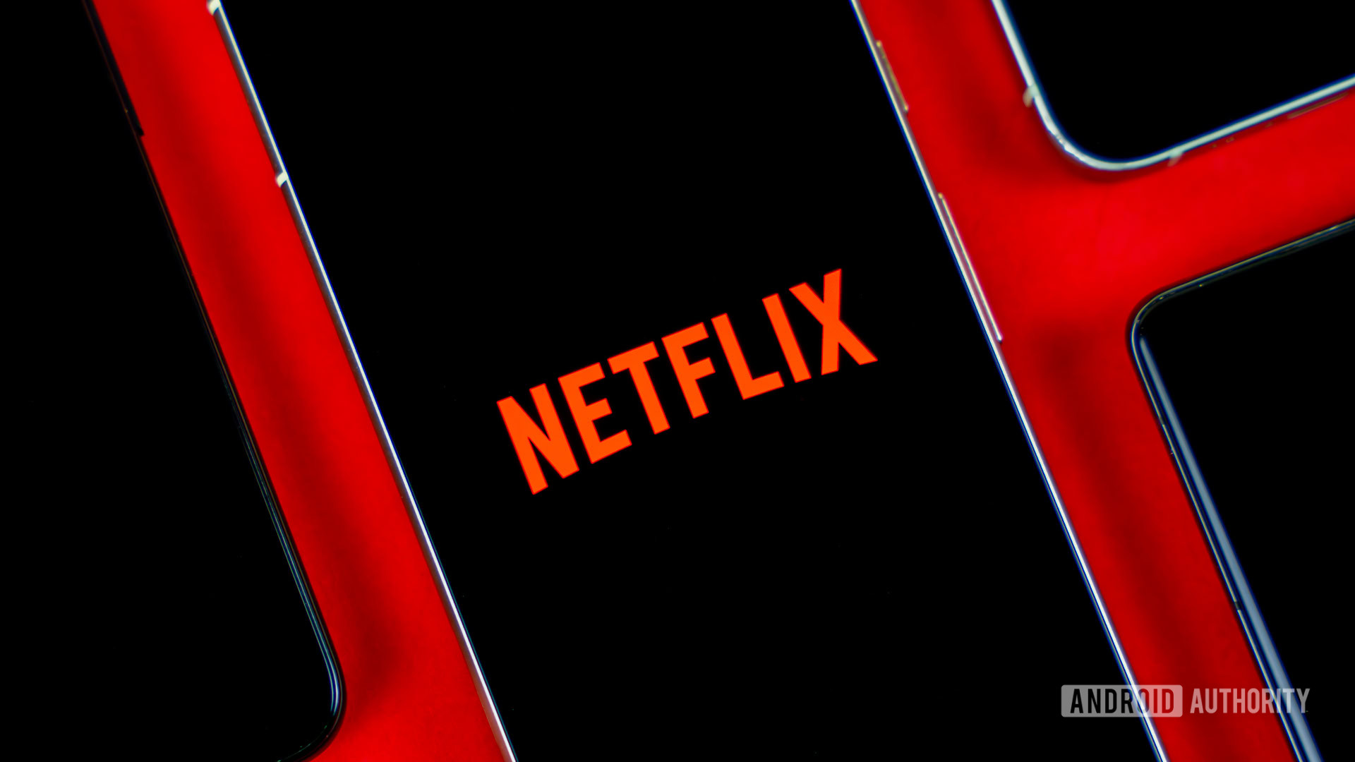 Netflix logo on smartphone, next to other devices stock photo (2)