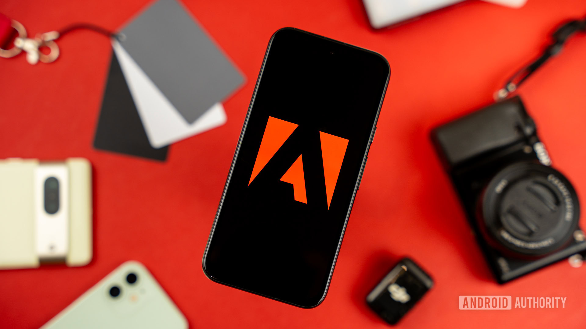 Adobe logo on smartphone, next to photography and videography products stock photo (5)