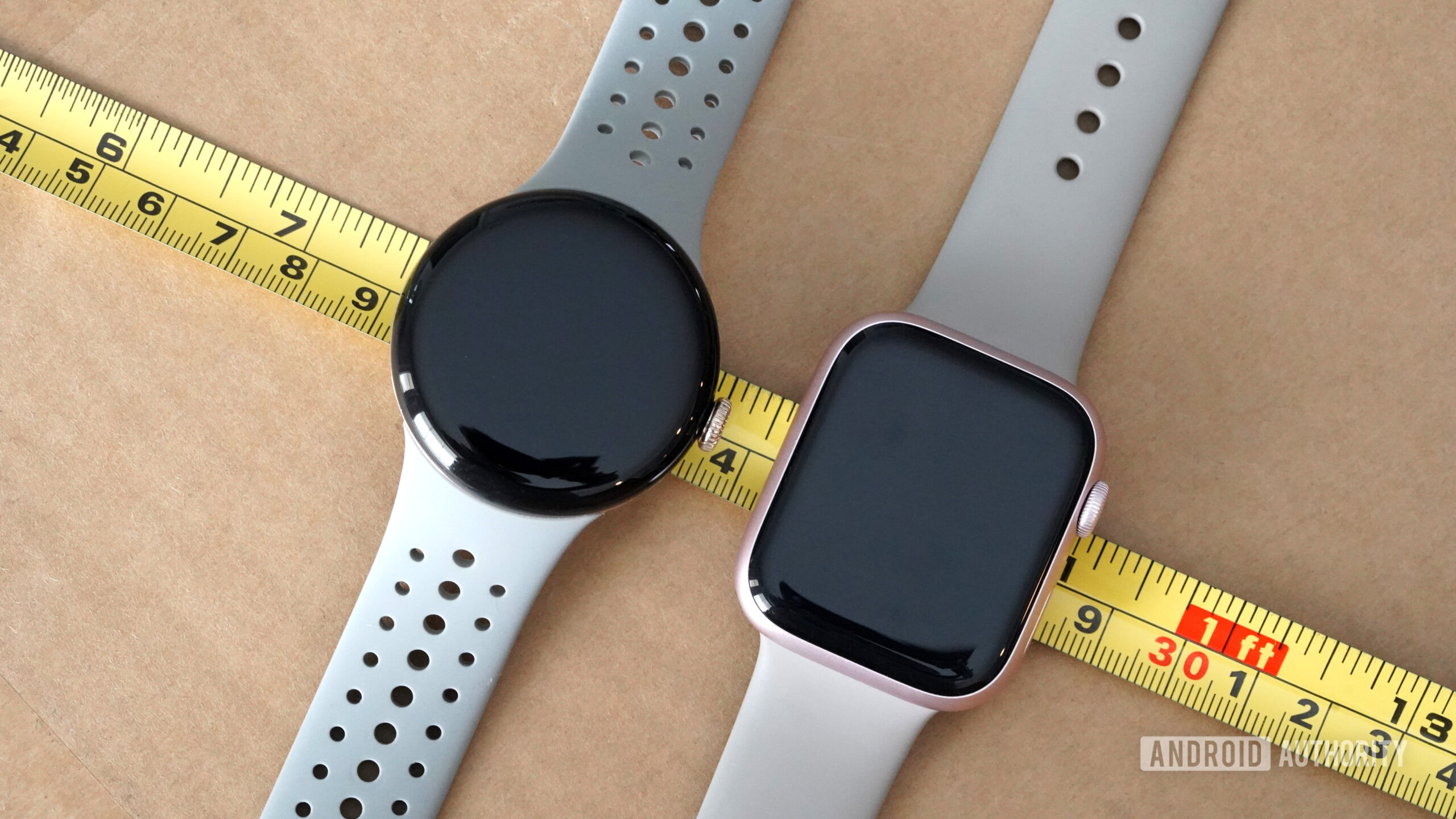 A 41mm Google Pixel Watch 2 rests alongside a 41mm Apple Watch Series 9.