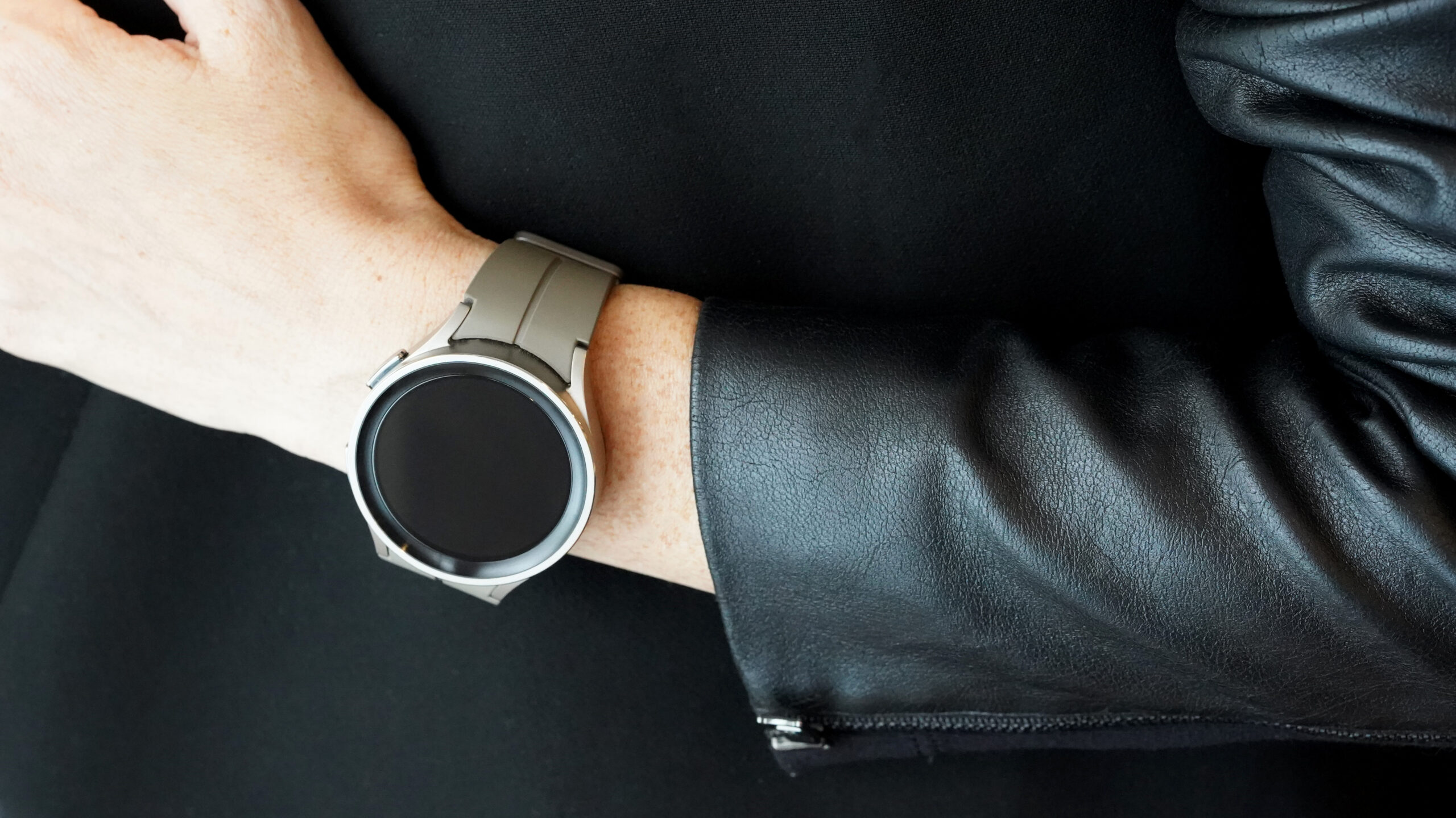 A Samsung Galaxy Watch 5 Pro on a user wrists displays a blank screen.
