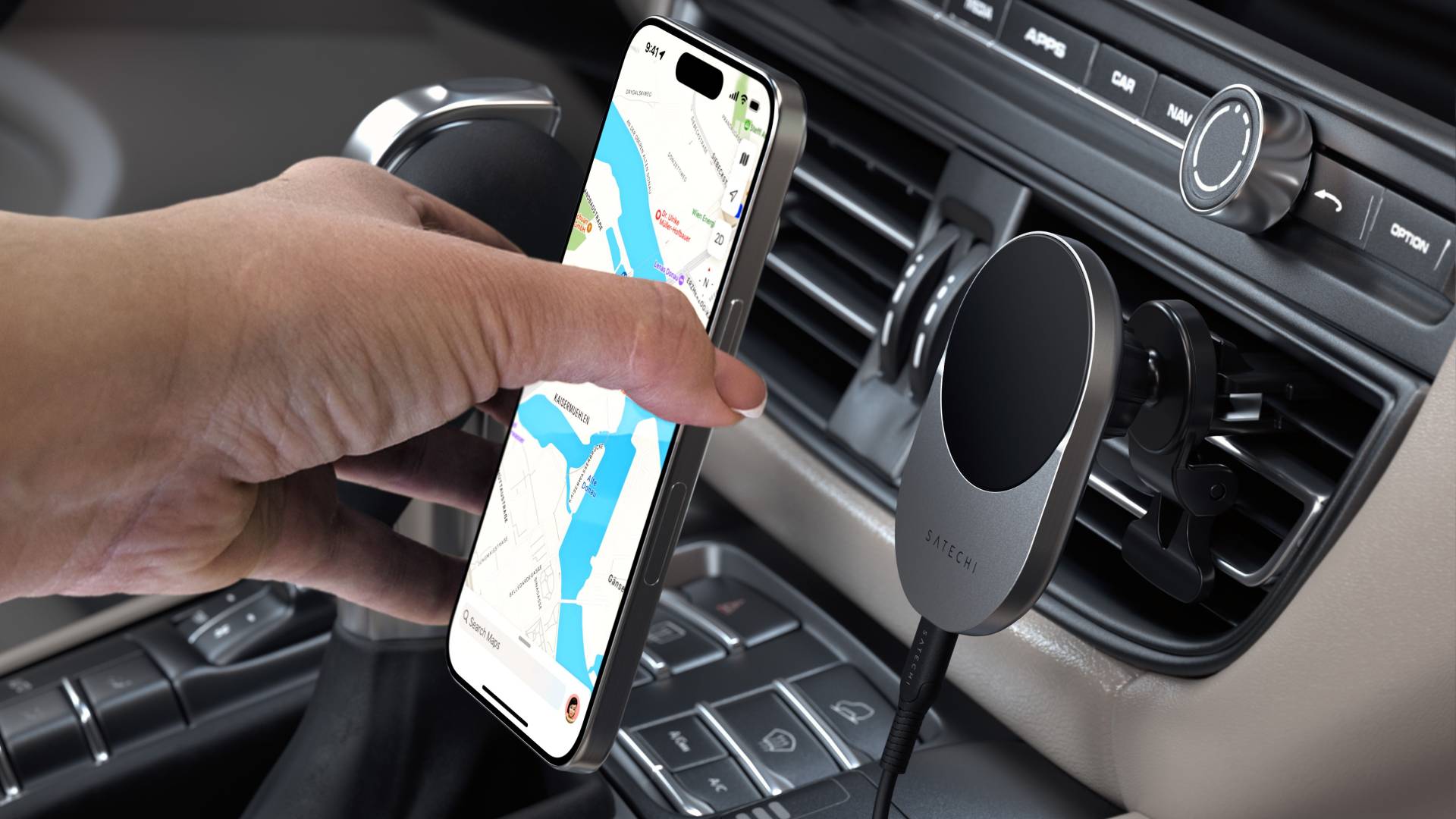 Person placing an iPhone on a Satechi Qi2 wireless charger mounted on a car's AC vent.