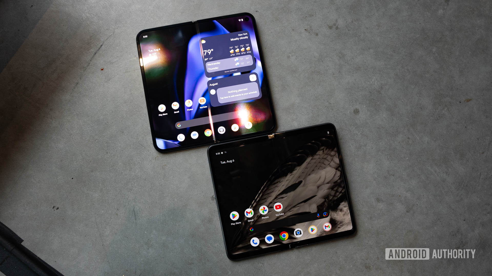 Google Pixel 9 Pro Fold and Google Pixel Fold opened on the floor with both displays on