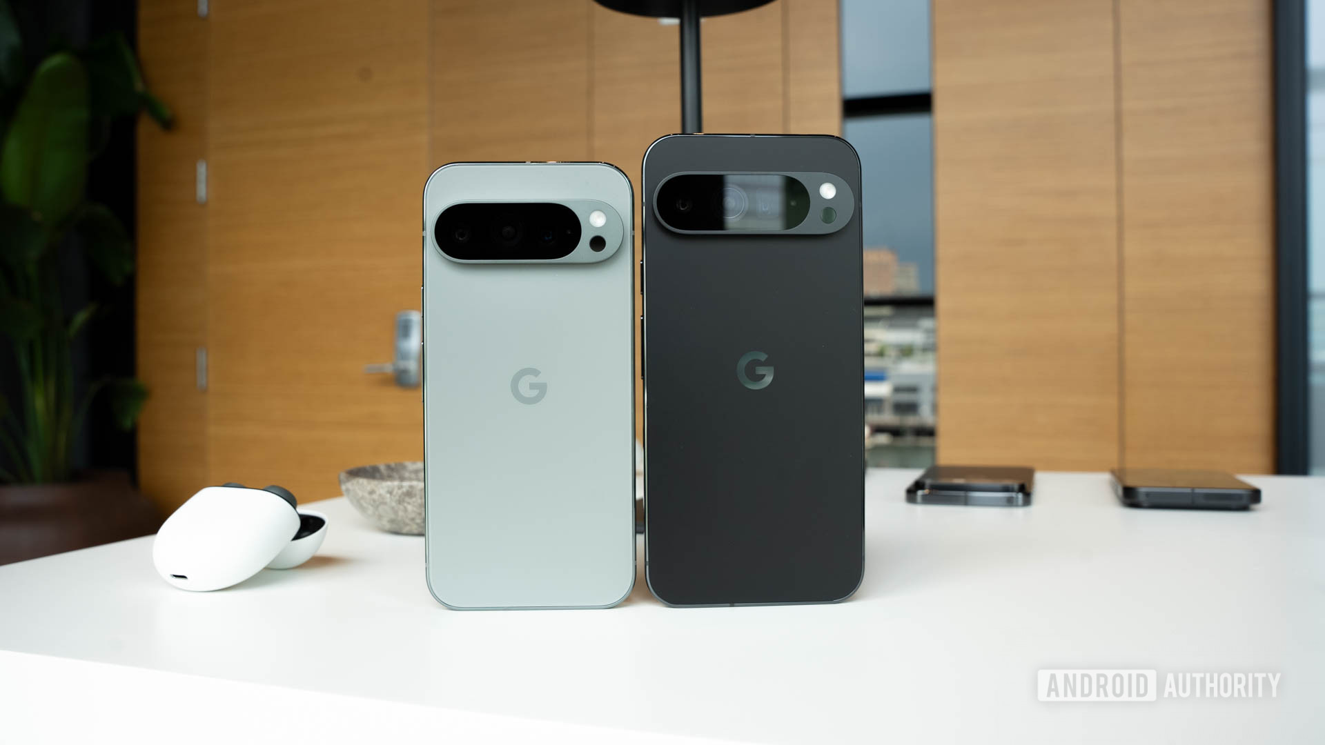 Google Pixel 9 Pro in Hazel standing next to Google Pixel 9 Pro XL in Obsidian