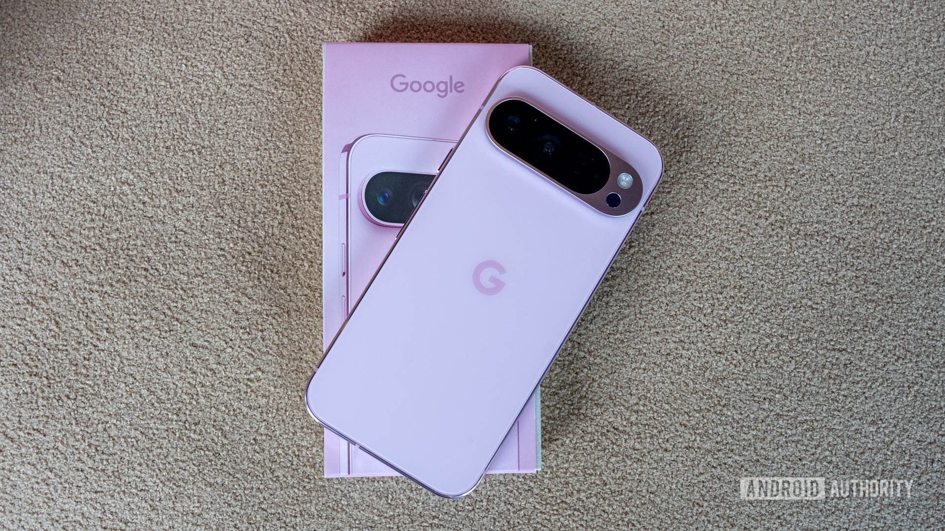 Google Pixel 9 Pro in Rose Quartz on top of its retail box