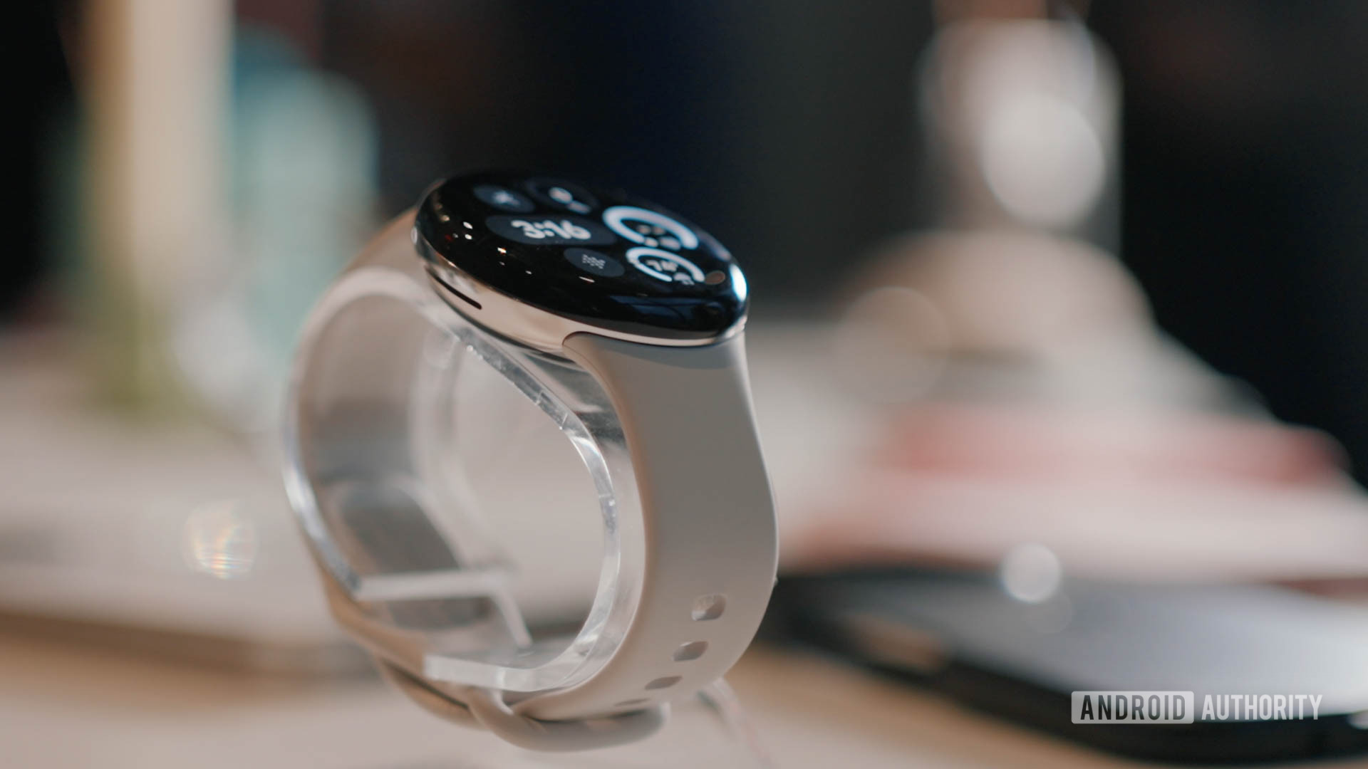 A Google Pixel Watch 3 rests on a display stand.