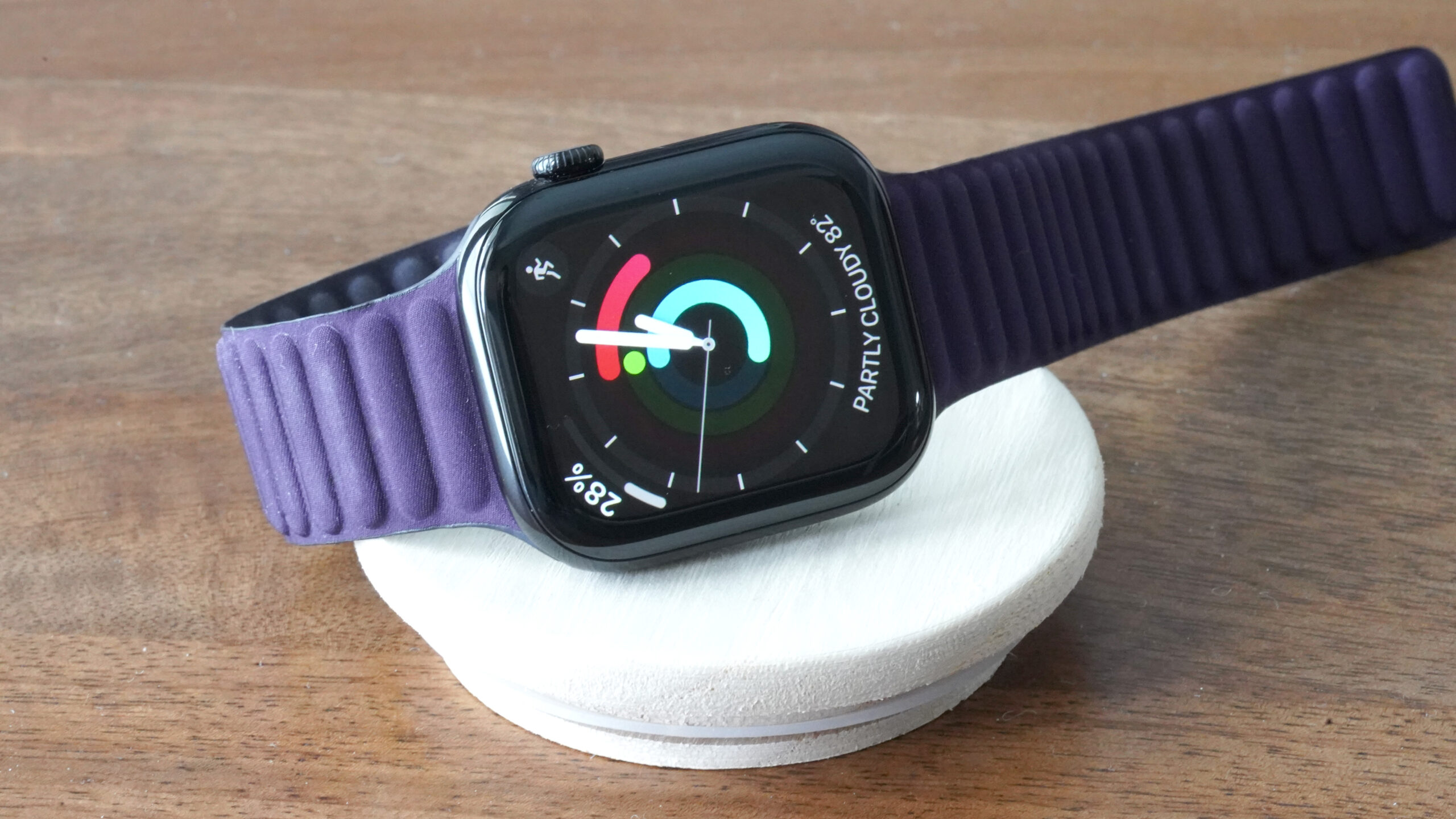 An Apple Watch Series 10 displays the Activity Analog watch face