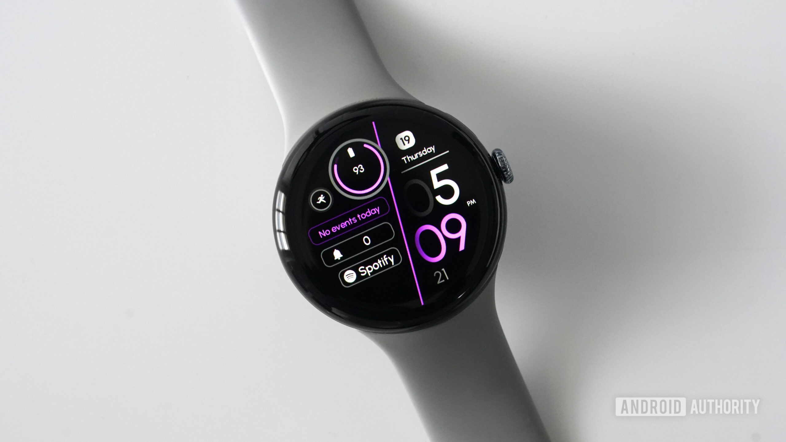 A Google Pixel Watch 3 displays the watch face RE55.