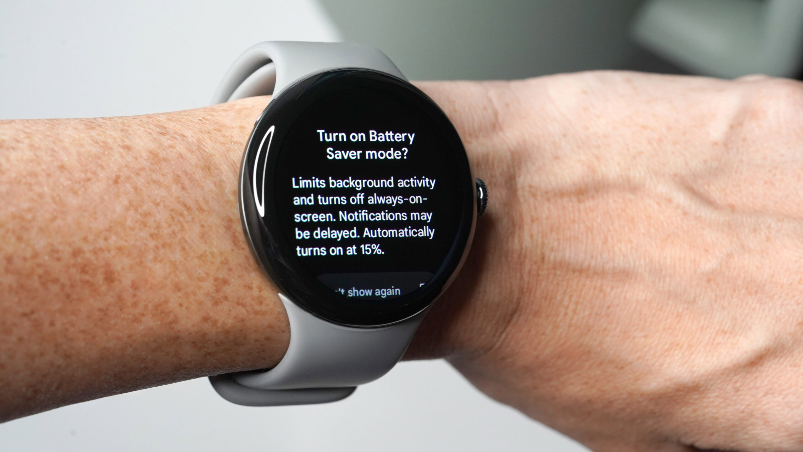 A Google Pixel Watch 3 on a user's wrists displays information about Battery Saver.