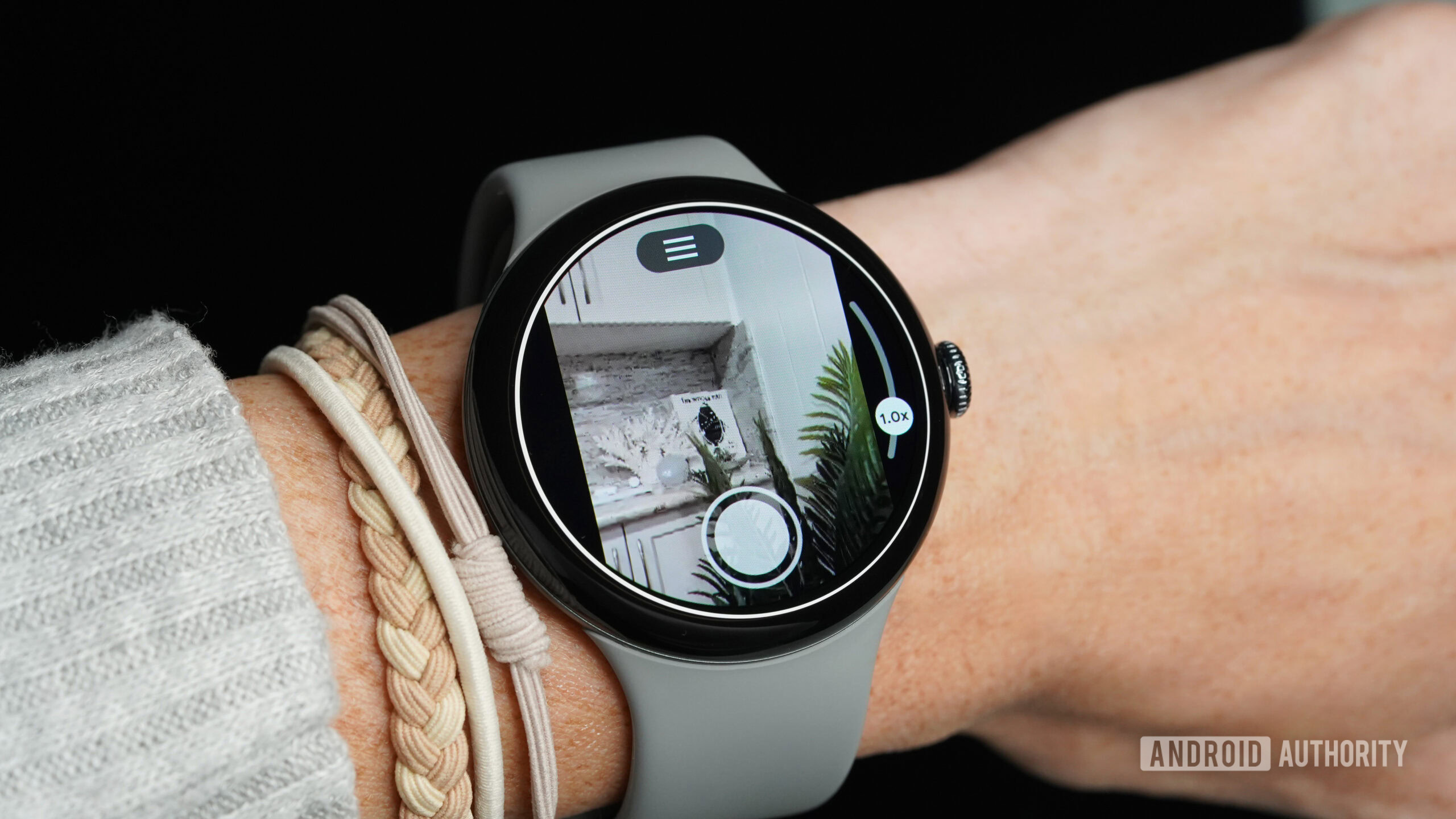 A Google Pixel Watch 3 manages the camera controls of their Pixel phone.