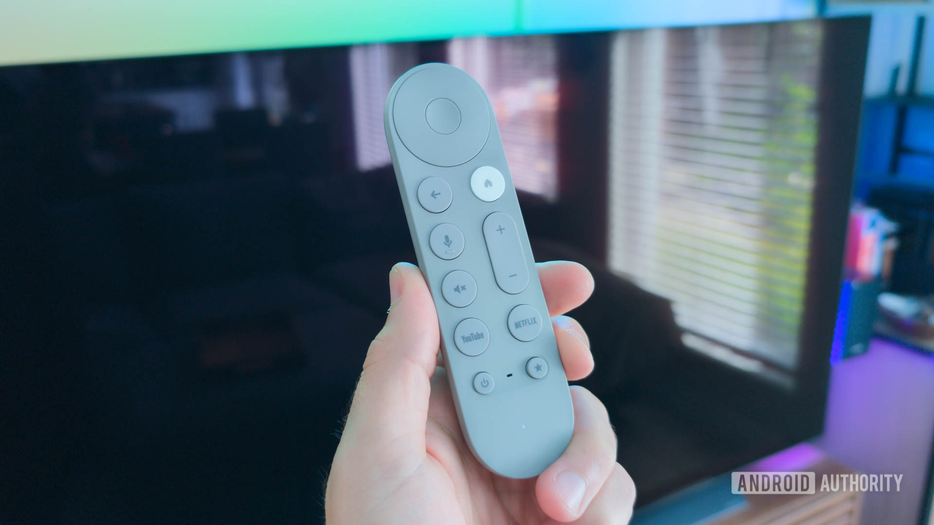 In front of an empty TV, with the Google TV streamer remote in hand.