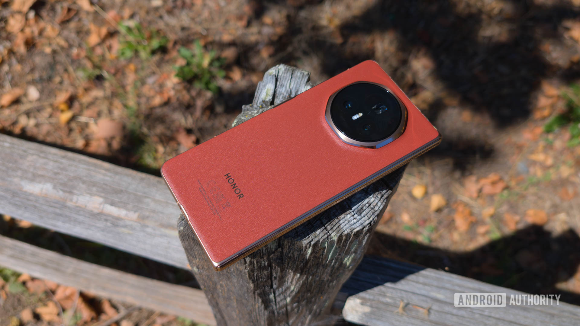 HONOR Magic V3 Resting on wooden fence showing Reddish Brown back