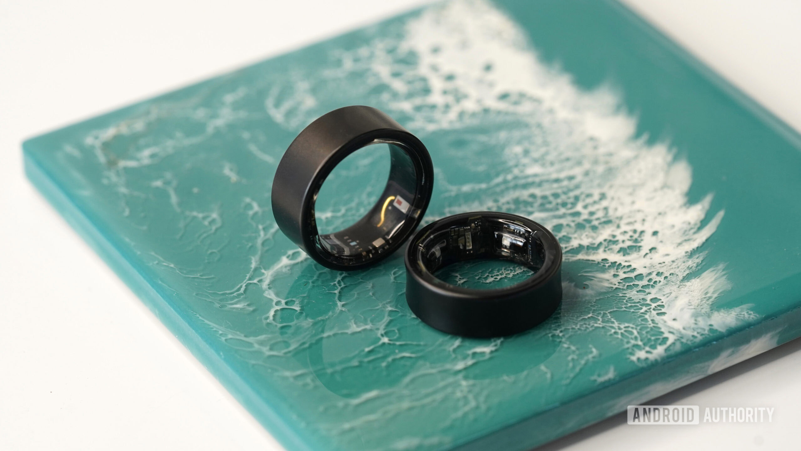 An Ultrahuman Ring Air rests alongside a Samsung Galaxy Ring.