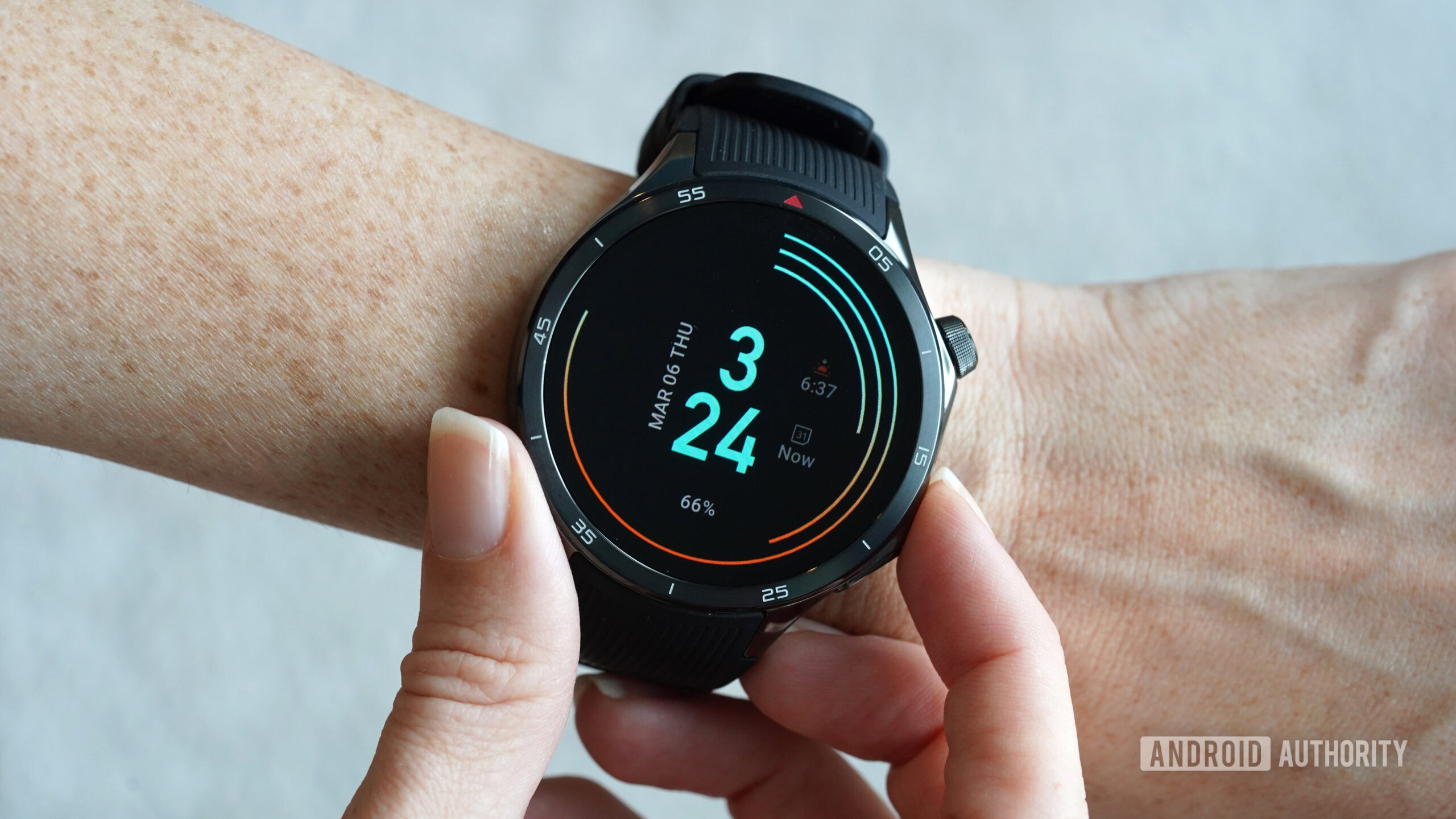 A OnePlus Watch 3 displays the JK 24 WearOS watch face.